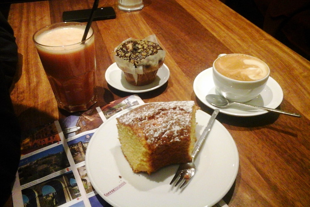 Pause gourmande à Luxembourg ville avec gâteau muffin et boissons.