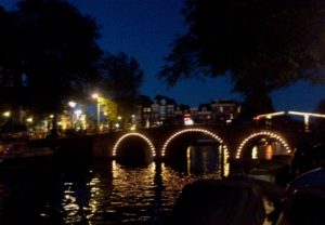 Pont illuminé Amsterdam la nuit.