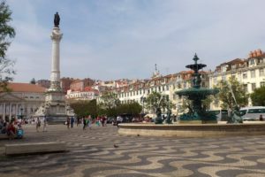 Place Rossio Lisbonne avec fontaines et colonne.